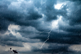 Lightning and thunderstorm flash with raining background.