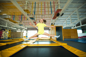 beautiful little girl jumping trampoline game club