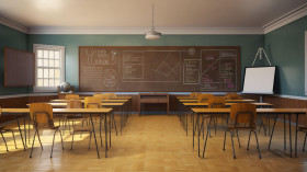 A dark and mysterious classroom with empty desks and chairs faci