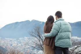 Happy young couple with a panoramic view in background. Love concept. Relationship happiness.