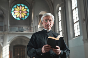 Senior priest standing in the church