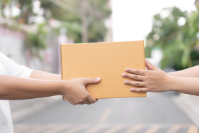 postal delivery courier delivering package customer outdoor